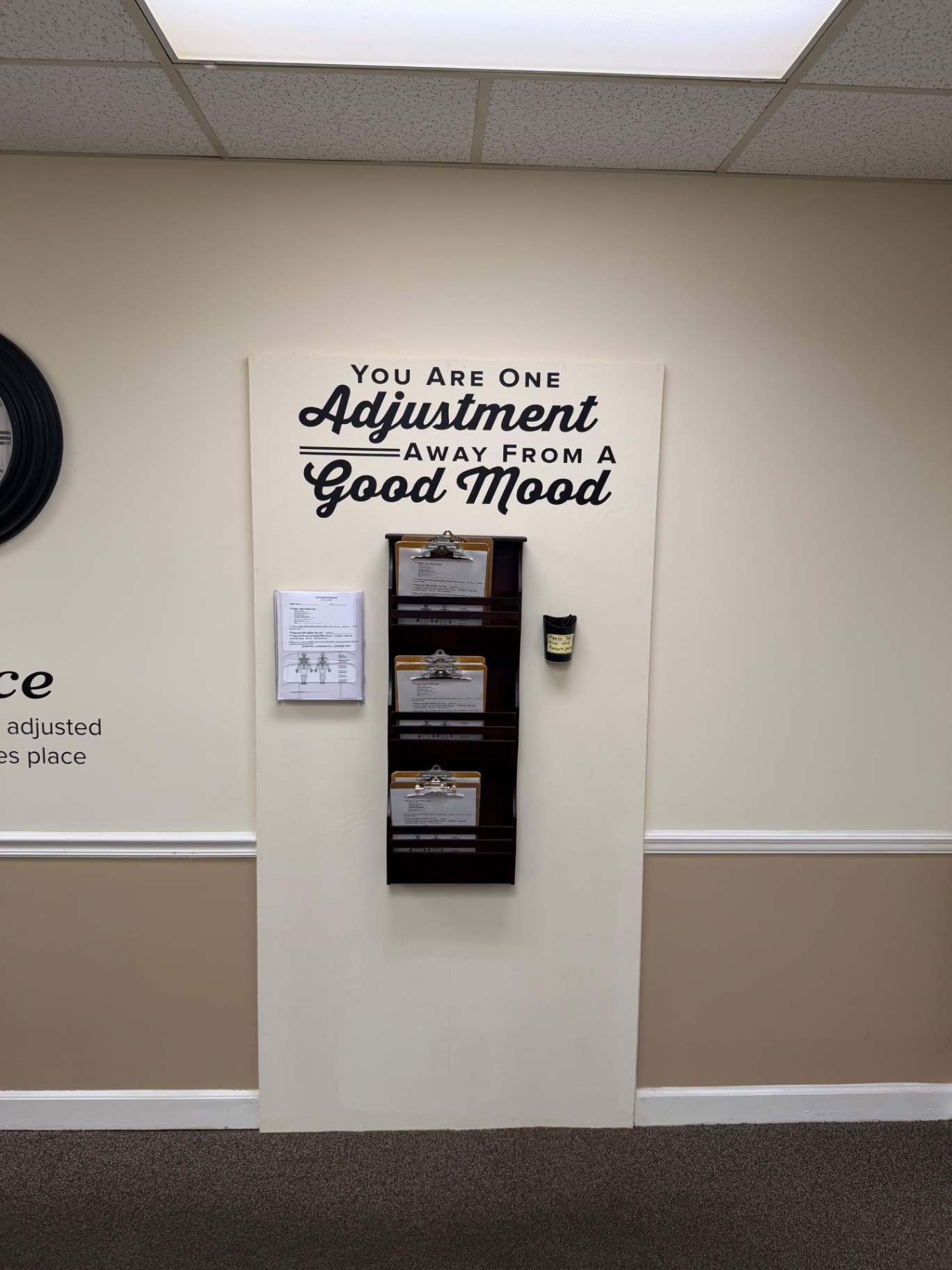 Patient clipboard station and wall art inside the office
