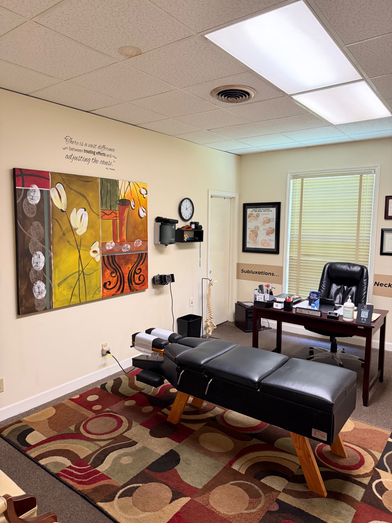 Treatment room with adjusting table and abstract artwork