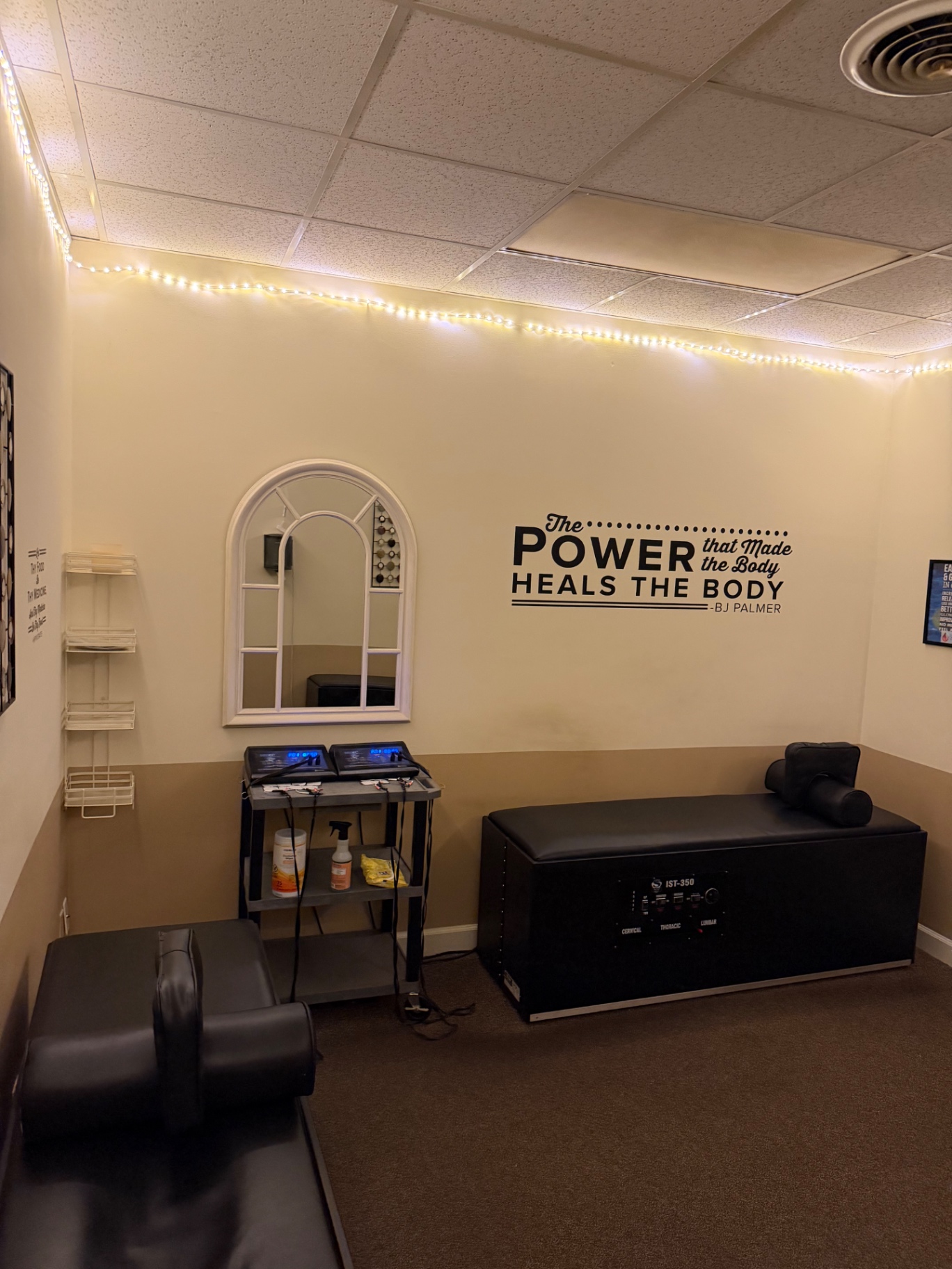 IST-350 therapy room with a treatment table, mirror and string lights